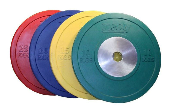 Four colored Troy Barbell Competition Bumper Plates (25, 20, 15 &amp; 10 kg) stacked together.